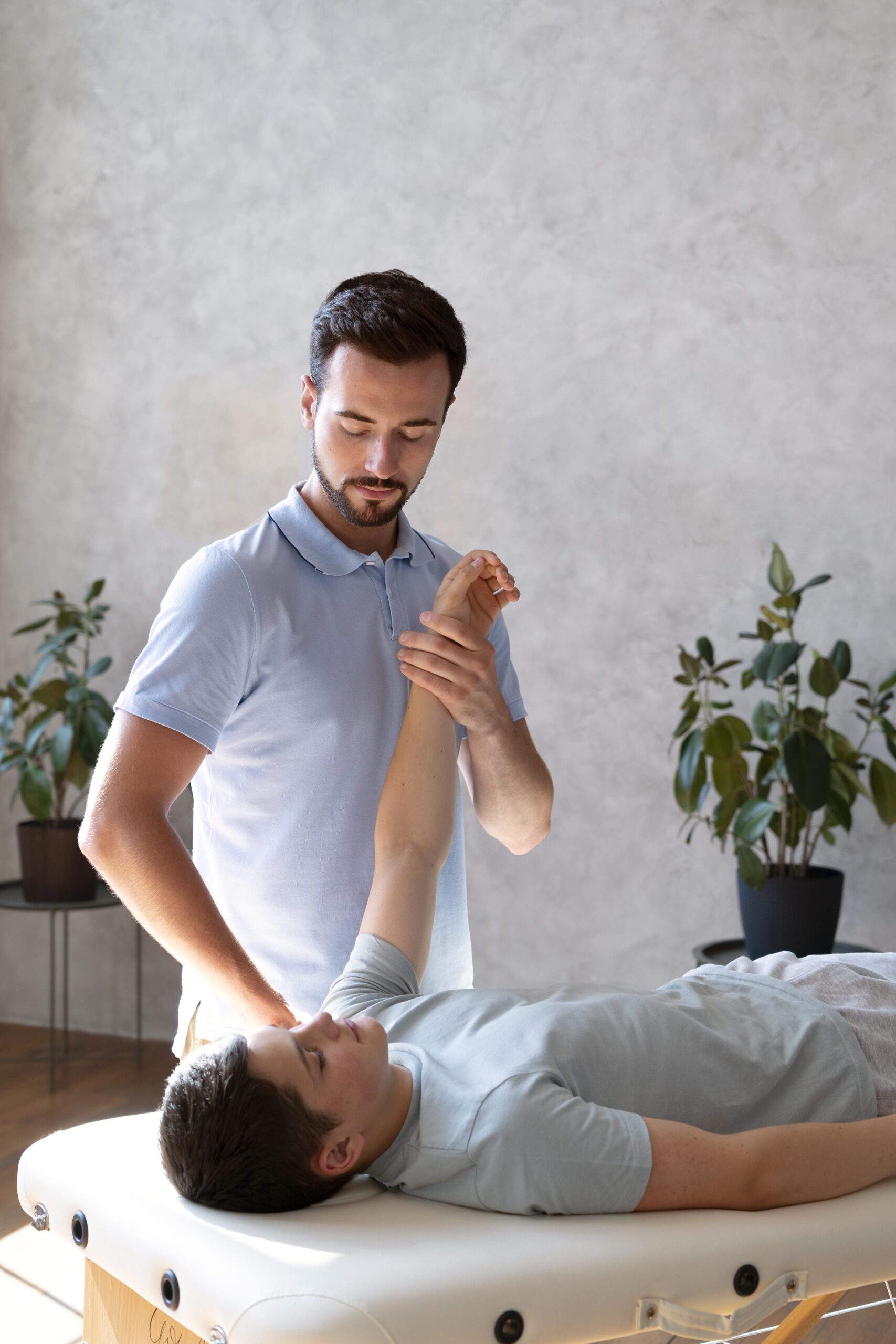medium shot physiotherapist checking arm